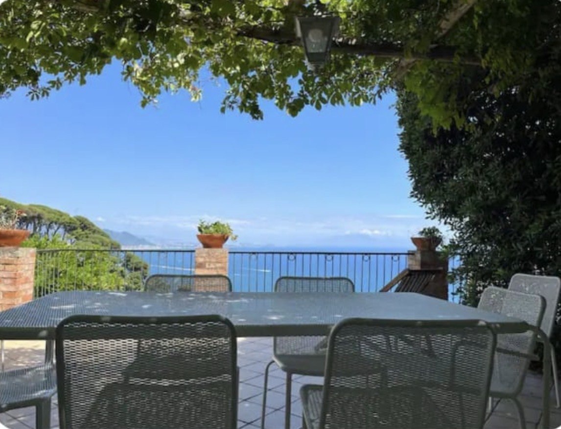 Tavolo esterno all'ombra con vista sul mare
